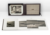 Collector’s Edition of Now Is Always by Vaune Trachtman, showing the presentation box with signed photogravure and the book opened to an image spread showing a man rowing a scull and two figures in the ocean.