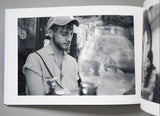 Open photo album showing a black and white photo of a person wearing a cap.