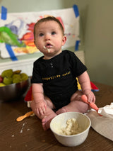 Storymatic Onesie: Competitive Eater (gold text)